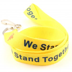 Yellow lanyard with blue "We Stand Together" text and red puzzle pieces